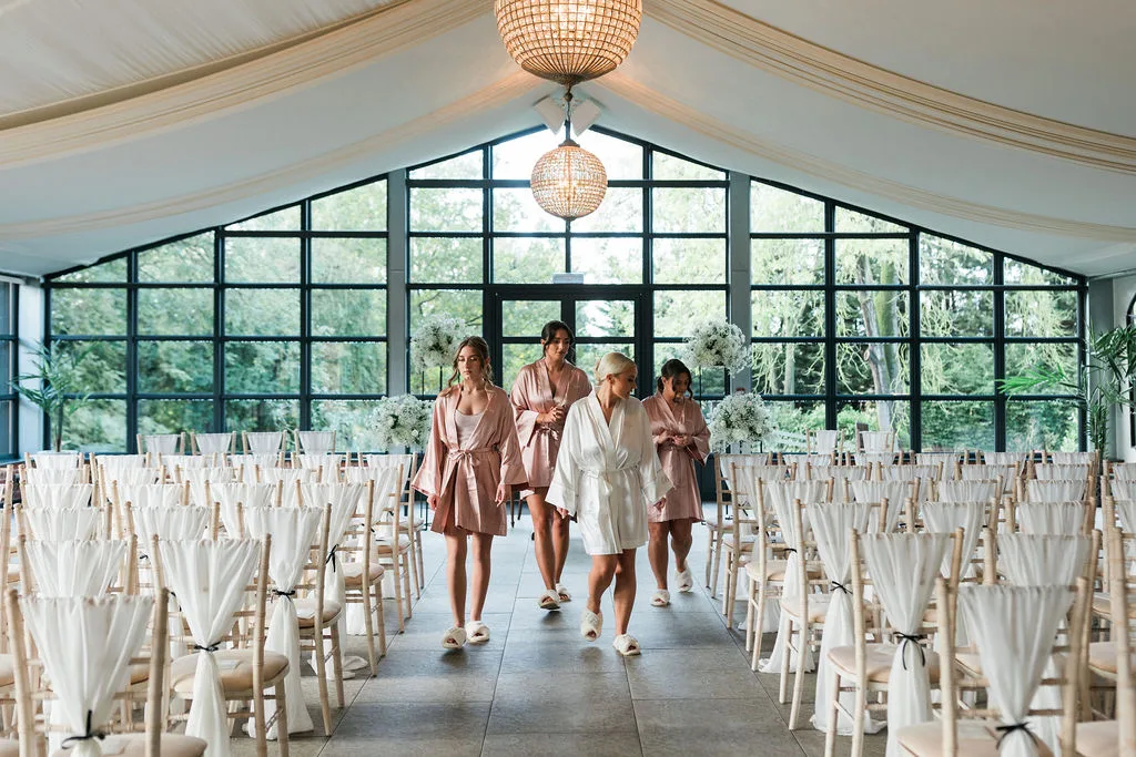 Bridal party walking through elegant wedding ceremony room