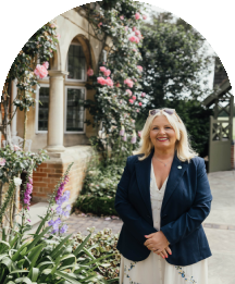Wedding team member smiling outside Baddow Park House