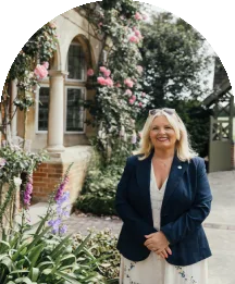 Wedding team member smiling outside Baddow Park House